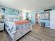 Well-lit bedroom featuring a seaside color palette, plank floors, and easy access to the bathroom at 7665 Sun Island S Dr # 401, South Pasadena, FL 33707