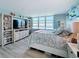 Bright and airy bedroom featuring a large window with waterfront views, complete with built-in shelving at 7665 Sun Island S Dr # 401, South Pasadena, FL 33707