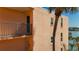 Condo exterior featuring a small balcony, palm tree, and view of the water at 7665 Sun Island S Dr # 401, South Pasadena, FL 33707