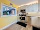 Bright kitchen featuring stainless steel appliances, white cabinets, and granite countertops at 7665 Sun Island S Dr # 401, South Pasadena, FL 33707