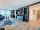 Living room with custom shelving and serene water views at 7665 Sun Island S Dr # 401, South Pasadena, FL 33707