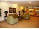 A well-lit lobby featuring comfortable seating, decorative lamps, artwork, and a tiled floor at 7665 Sun Island S Dr # 401, South Pasadena, FL 33707