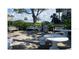 Community picnic area features seating, tables, a grilling station, and lush landscaping at 7665 Sun Island S Dr # 401, South Pasadena, FL 33707