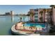 Condo building near water with a clear blue pool and a decorative fence at 7665 Sun Island S Dr # 401, South Pasadena, FL 33707