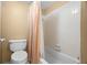 Bathroom with a toilet and bathtub with a shower behind a shower curtain at 7701 Starkey Rd # 526, Seminole, FL 33777