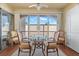 Bright dining area featuring a glass table, four chairs, and sliding glass doors to the balcony at 7701 Starkey Rd # 526, Seminole, FL 33777