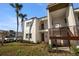 Inviting condo complex with lush landscaping, featuring a welcoming entryway with stair access to the upper level units at 7701 Starkey Rd # 526, Seminole, FL 33777