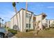 Condo exterior with lush landscape, showcasing the architecture with well-maintained lawns and palm trees at 7701 Starkey Rd # 526, Seminole, FL 33777