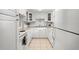 Bright kitchen featuring white cabinetry, neutral countertops, and a tile backsplash at 7701 Starkey Rd # 526, Seminole, FL 33777