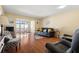 Comfortable living room featuring hardwood floors, a leather sofa, and access to the balcony at 7701 Starkey Rd # 526, Seminole, FL 33777