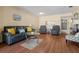 Cozy living room with hardwood floors, comfortable seating, and an open view to the kitchen at 7701 Starkey Rd # 526, Seminole, FL 33777