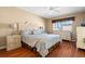 Cozy bedroom with wood floors, ceiling fan and window with natural light at 7701 Starkey Rd # 526, Seminole, FL 33777