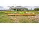 A shot of the back of the home featuring a garden bed near the house at 7735 Wauchula Rd, Myakka City, FL 34251