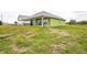 View of the home's backyard, highlighting the spacious open area that surrounds the property at 7735 Wauchula Rd, Myakka City, FL 34251