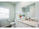 Well-lit bathroom featuring a granite countertop, white cabinets, and a large mirror at 7735 Wauchula Rd, Myakka City, FL 34251