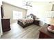 Bedroom featuring a ceiling fan, wood-look floors, and a decorative bed frame at 7735 Wauchula Rd, Myakka City, FL 34251