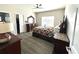 Bedroom featuring a ceiling fan, wood-look floors, and decorative dressers at 7735 Wauchula Rd, Myakka City, FL 34251