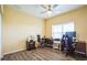 Bedroom featuring a ceiling fan, wood-look floors, and multiple workstations at 7735 Wauchula Rd, Myakka City, FL 34251
