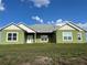 Exterior shot of a single-Gathering home with a well-maintained lawn and a welcoming front entrance at 7735 Wauchula Rd, Myakka City, FL 34251