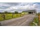 The side exterior view showcases an expansive yard and a well-maintained driveway leading to the home at 7735 Wauchula Rd, Myakka City, FL 34251