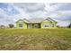 Exterior shot of a single-Gathering home, highlighting its well-maintained lawn and inviting curb appeal at 7735 Wauchula Rd, Myakka City, FL 34251
