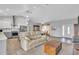 Inviting living room featuring an open floor plan with a vaulted ceiling and light hardwood floors at 7735 Wauchula Rd, Myakka City, FL 34251