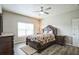 Bright main bedroom with light grey walls, ceiling fan, and wood-look flooring at 7735 Wauchula Rd, Myakka City, FL 34251