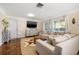 Spacious living room featuring hardwood floors, a large sectional sofa, and a neutral color palette at 774 29Th N Ave, St Petersburg, FL 33704