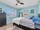 Bedroom with a ceiling fan, large windows and light blue painted walls at 7882 42Nd N Ave, St Petersburg, FL 33709