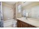 Bathroom with a tiled shower and bathtub, a wood vanity, and ample counter space at 824 Islebay Dr, Apollo Beach, FL 33572