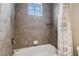 A bathroom with a tiled shower and tub, a window, and modern fixtures, creating a cozy and functional space at 824 Islebay Dr, Apollo Beach, FL 33572