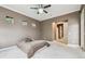 A bedroom with neutral walls has carpet and 2 small windows, along with a ceiling fan at 824 Islebay Dr, Apollo Beach, FL 33572