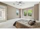 This bright bedroom boasts an adjacent door to the screened porch with an overhead fan at 824 Islebay Dr, Apollo Beach, FL 33572