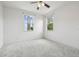 A spacious bedroom with plush carpeting and two windows, providing natural light and comfort at 824 Islebay Dr, Apollo Beach, FL 33572