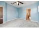 A carpeted bedroom featuring a ceiling fan and an ensuite bathroom, creating a comfortable and private space at 824 Islebay Dr, Apollo Beach, FL 33572