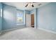 Bright bedroom featuring a window with a view, light blue walls, and plush carpeting throughout at 824 Islebay Dr, Apollo Beach, FL 33572