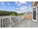 Spacious deck with white railing offers a beautiful view of the surrounding landscape and neighborhood at 824 Islebay Dr, Apollo Beach, FL 33572