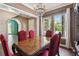 Formal dining room featuring a crystal chandelier, large windows, and seating for six at 824 Islebay Dr, Apollo Beach, FL 33572