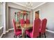 Elegant dining room featuring a large table, china cabinet, chandelier, and red upholstered chairs at 824 Islebay Dr, Apollo Beach, FL 33572