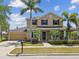 Charming two-story home featuring lush landscaping, a two-car garage, and a welcoming front porch at 824 Islebay Dr, Apollo Beach, FL 33572