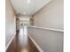 Second-story hallway boasts wood flooring and an open view of the screened porch with pool at 824 Islebay Dr, Apollo Beach, FL 33572
