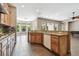 Well-lit kitchen with granite countertops, wooden cabinets, and ample countertop space at 824 Islebay Dr, Apollo Beach, FL 33572