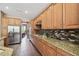 Open kitchen with stainless steel appliances, granite countertops, and tile backsplash at 824 Islebay Dr, Apollo Beach, FL 33572