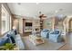 Bright living room features a cozy fireplace, a ceiling fan, and a staircase at 824 Islebay Dr, Apollo Beach, FL 33572
