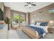 Beautiful main bedroom featuring a wicker bed frame, sitting area, and bright, open windows at 824 Islebay Dr, Apollo Beach, FL 33572