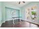 Clean and modern office space with adjustable desk and natural light from the doors at 824 Islebay Dr, Apollo Beach, FL 33572