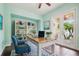 Bright home office with built-in bookcase, desk, and french doors to outdoor patio at 824 Islebay Dr, Apollo Beach, FL 33572