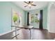 Stylish office offering an adjustable desk and views from the patio and yard at 824 Islebay Dr, Apollo Beach, FL 33572