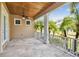 A covered patio with tiled floor and a view of the well-maintained yard at 824 Islebay Dr, Apollo Beach, FL 33572