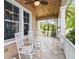 Cozy covered porch, perfect for relaxing, with two rocking chairs and view of the garden at 824 Islebay Dr, Apollo Beach, FL 33572
